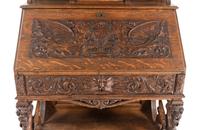 A Renaissance Revival Carved Oak Slant-Front Bureau