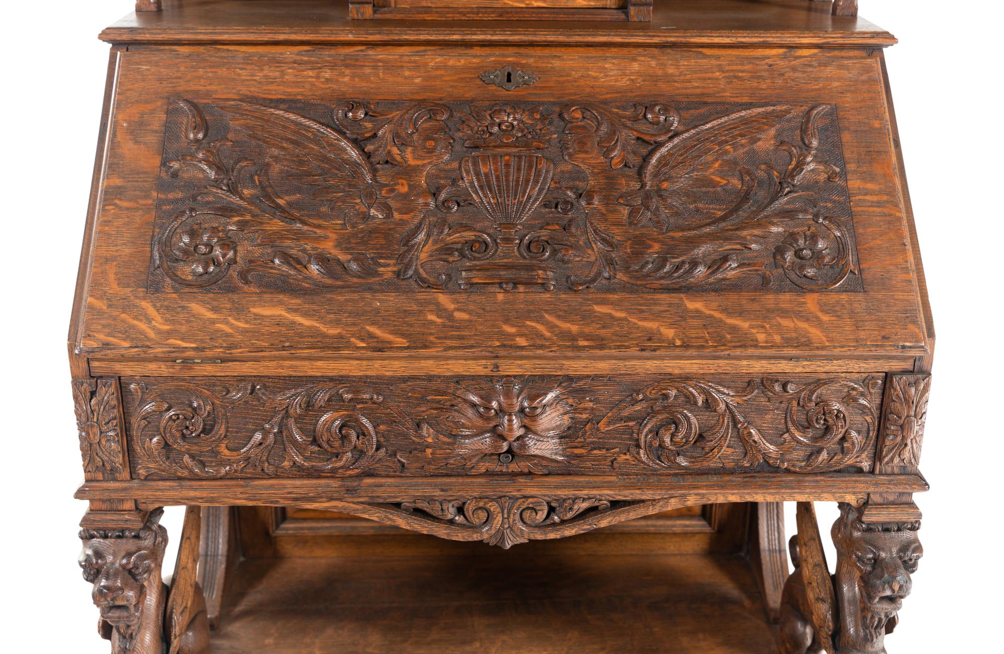 A Renaissance Revival Carved Oak Slant-Front Bureau