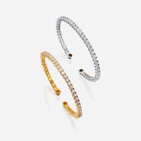 A pair of diamond and fourteen karat gold bangles