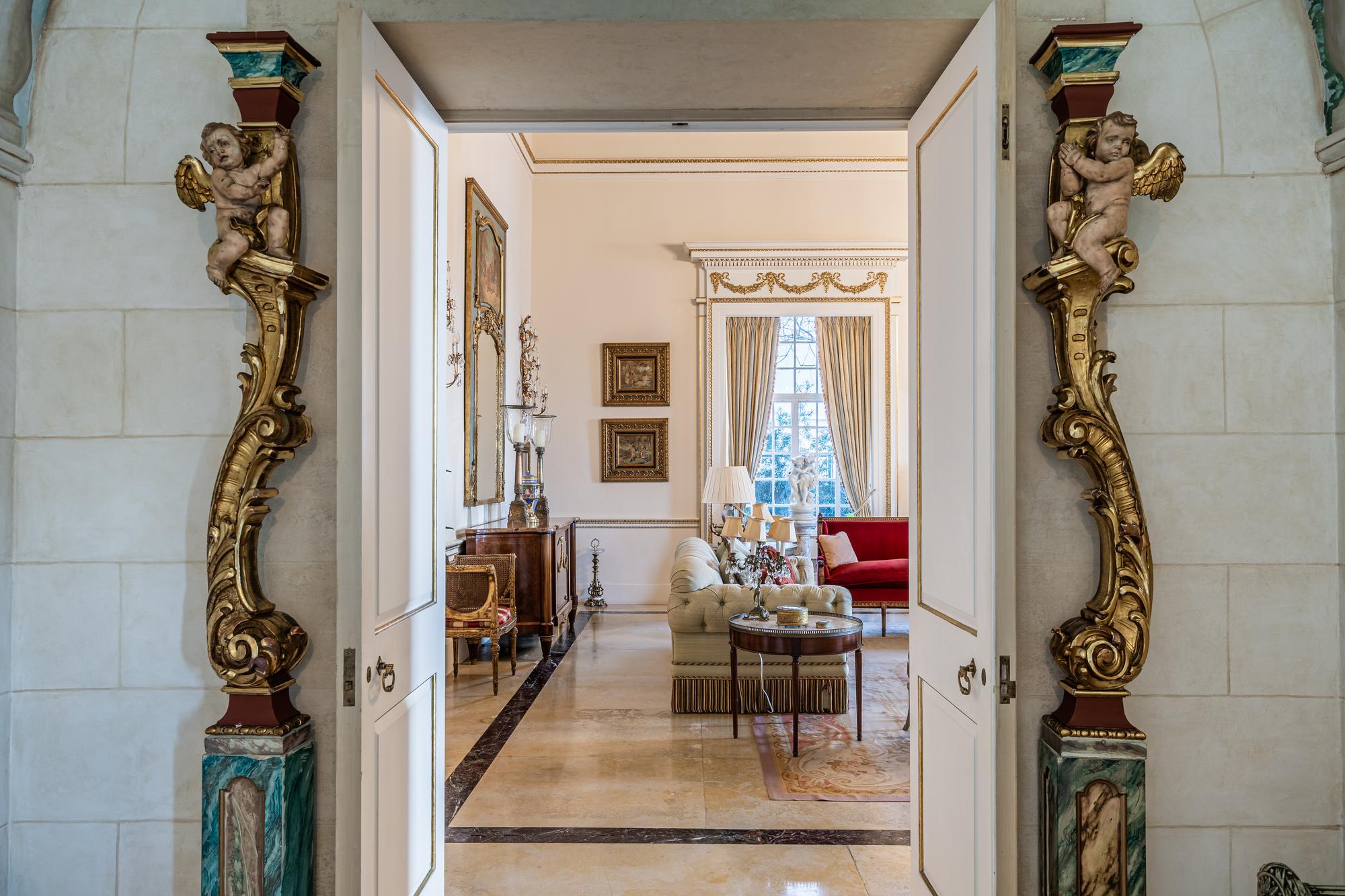 A Pair of Venetian Painted and Parcel Gilt Columns with Putti