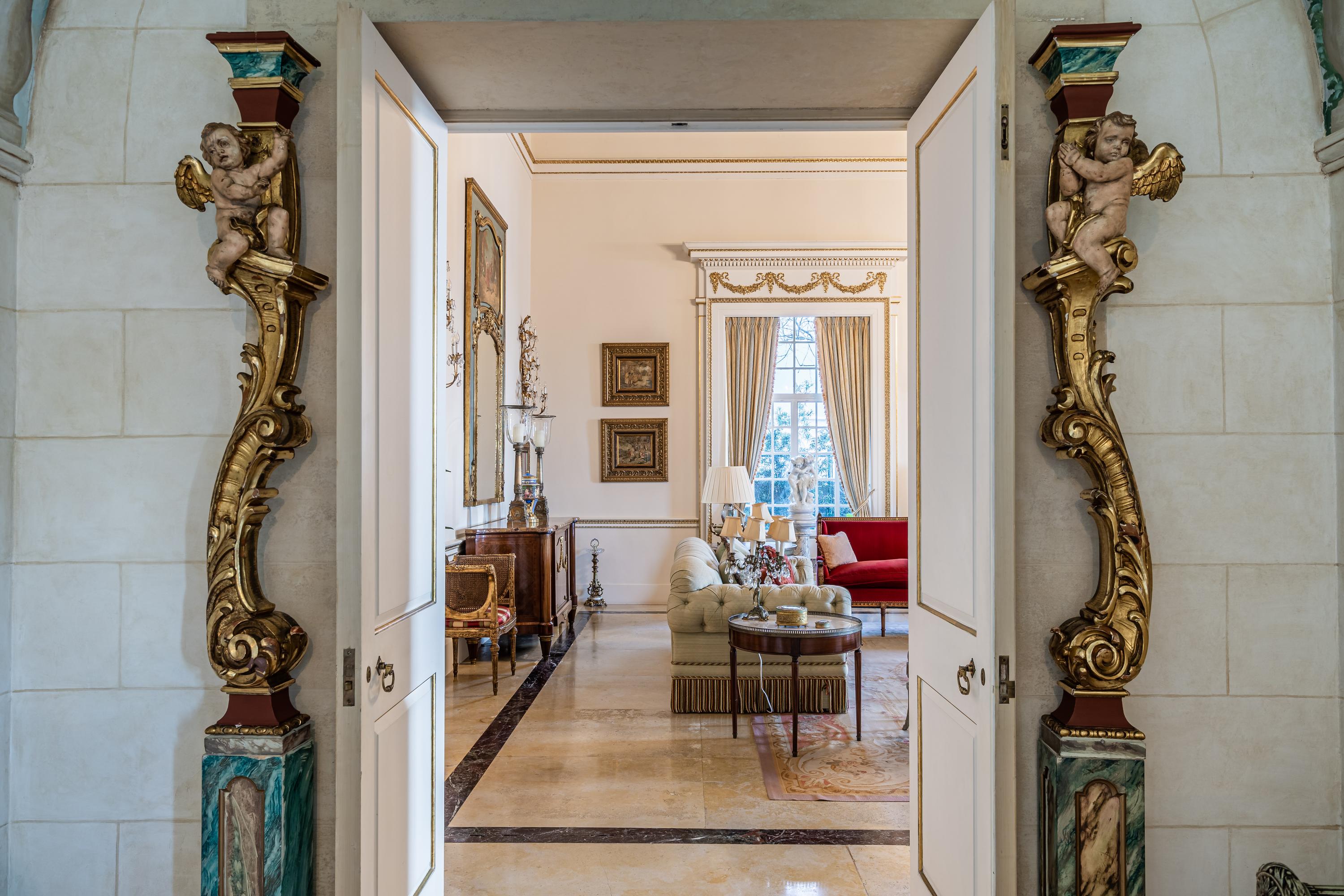 A Pair of Venetian Painted and Parcel Gilt Columns with Putti