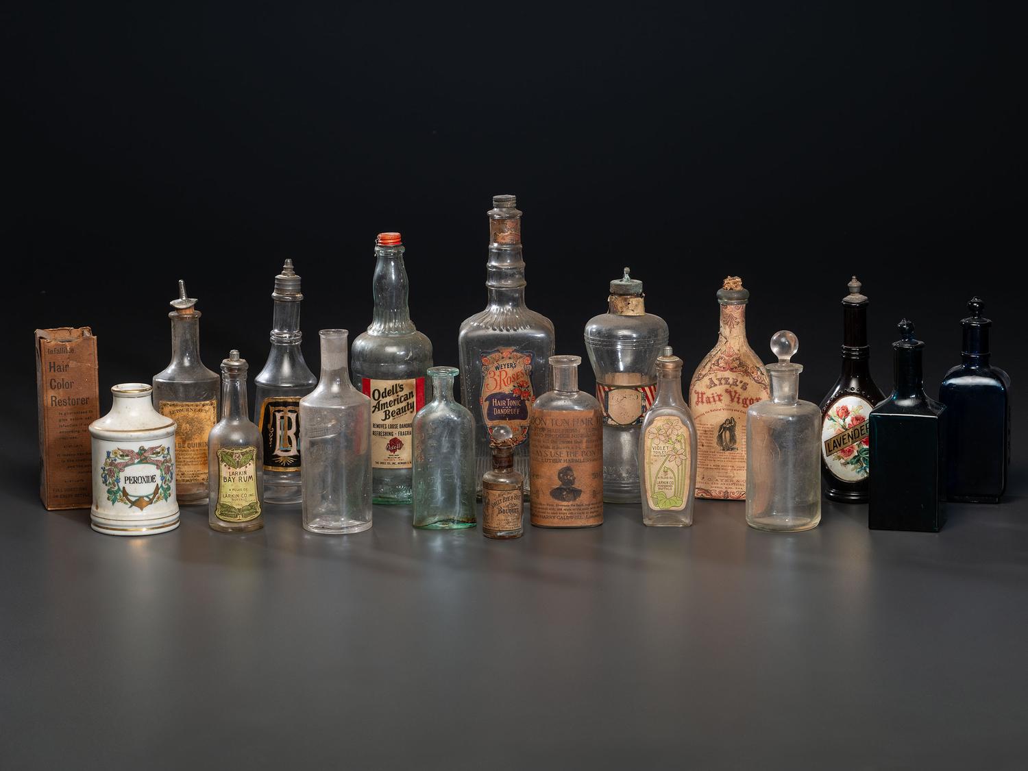 Eighteen Pressed Glass and Porcelain Hair Tonic Bottles