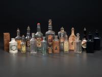 Eighteen Pressed Glass and Porcelain Hair Tonic Bottles