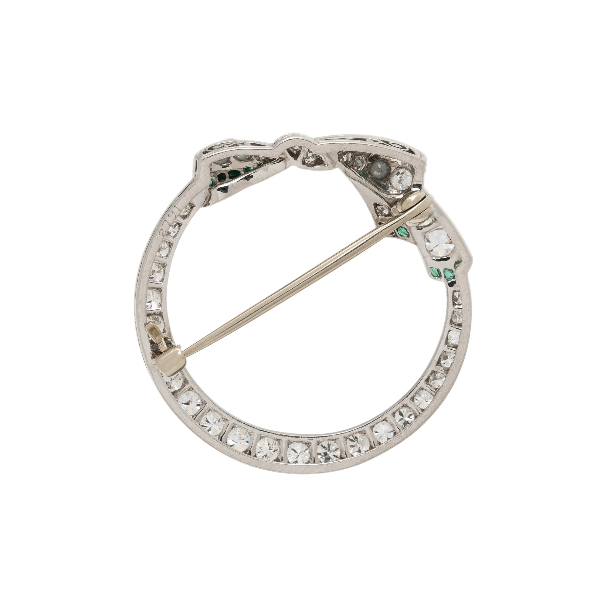 PLATINUM, DIAMOND, AND EMERALD BROOCH