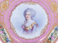 A Pair of Sèvres Painted and Parcel Gilt Pink-Ground Porcelain Plates