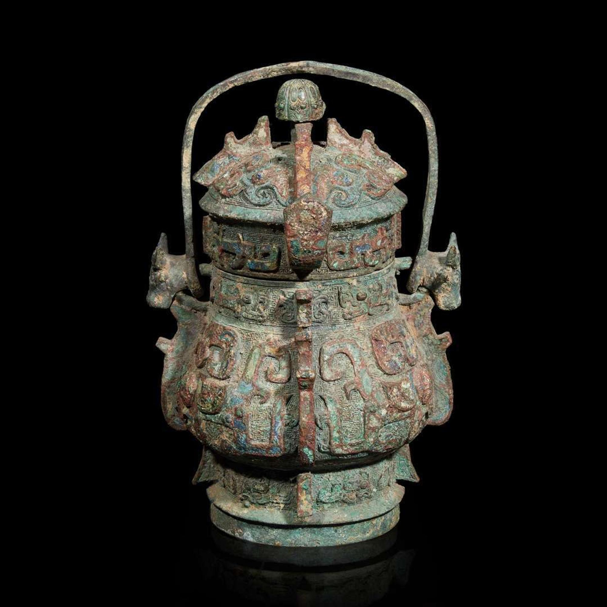 A Chinese archaistic bronze covered ritual wine vessel, You 青銅提梁卣
