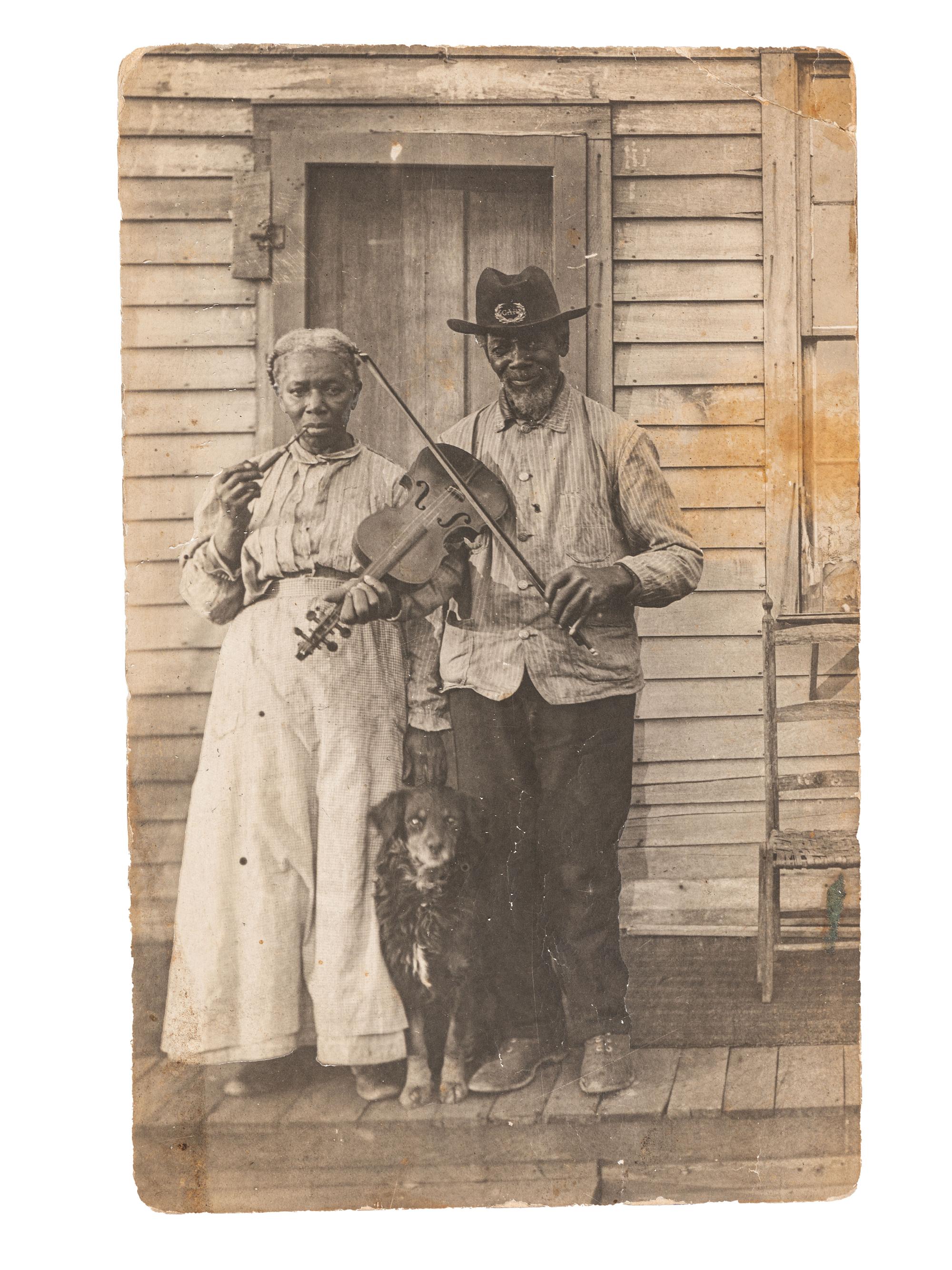 [EARLY PHOTOGRAPHY]. Real photo postcard of a formerly enslaved couple, incl. a Civil War veteran.