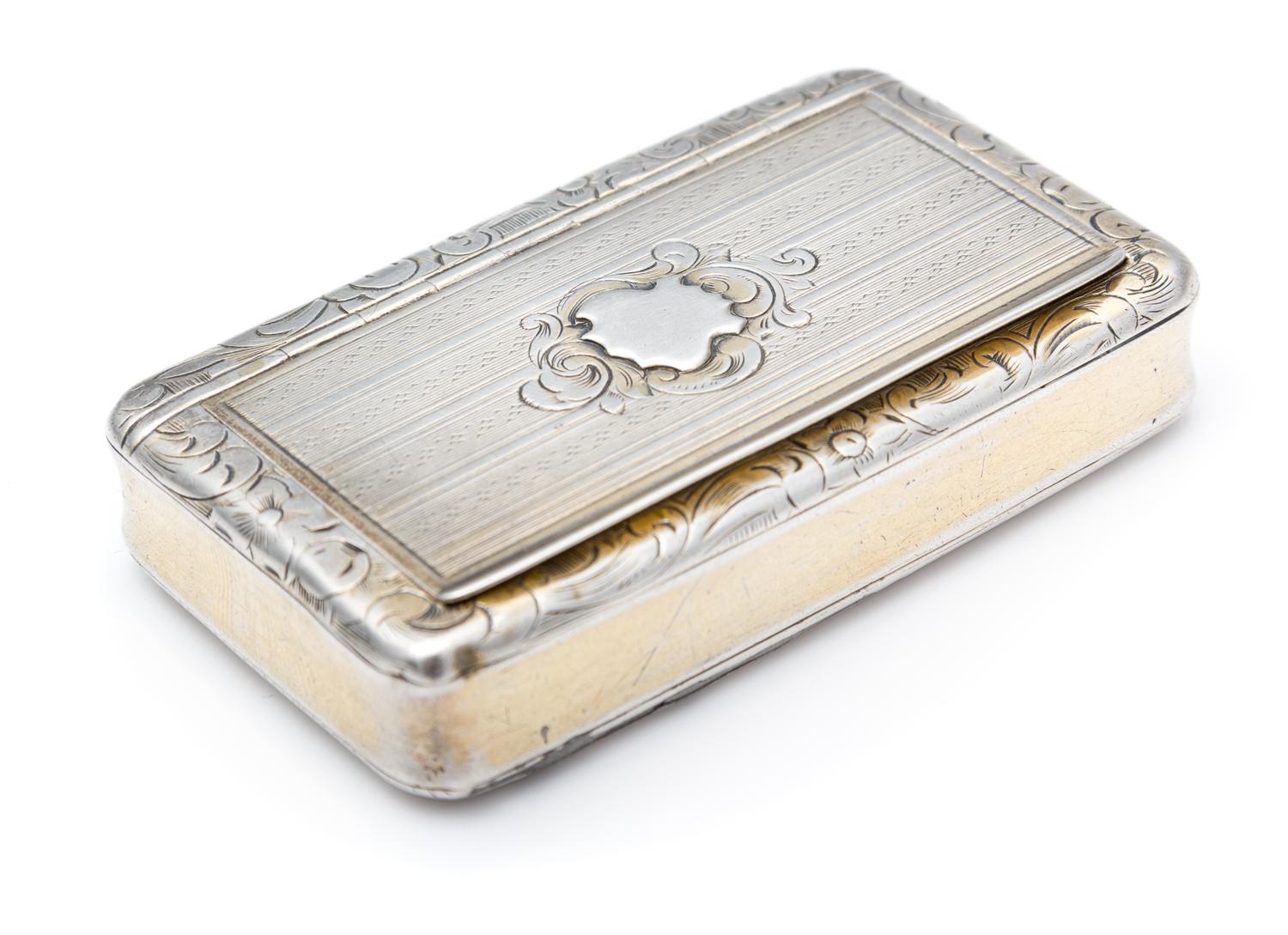 A French Silver Snuff Box, Maker's Mark Obscured, of rectangular form, the lid rim worked to show floral and foliate motifs, the lid wi