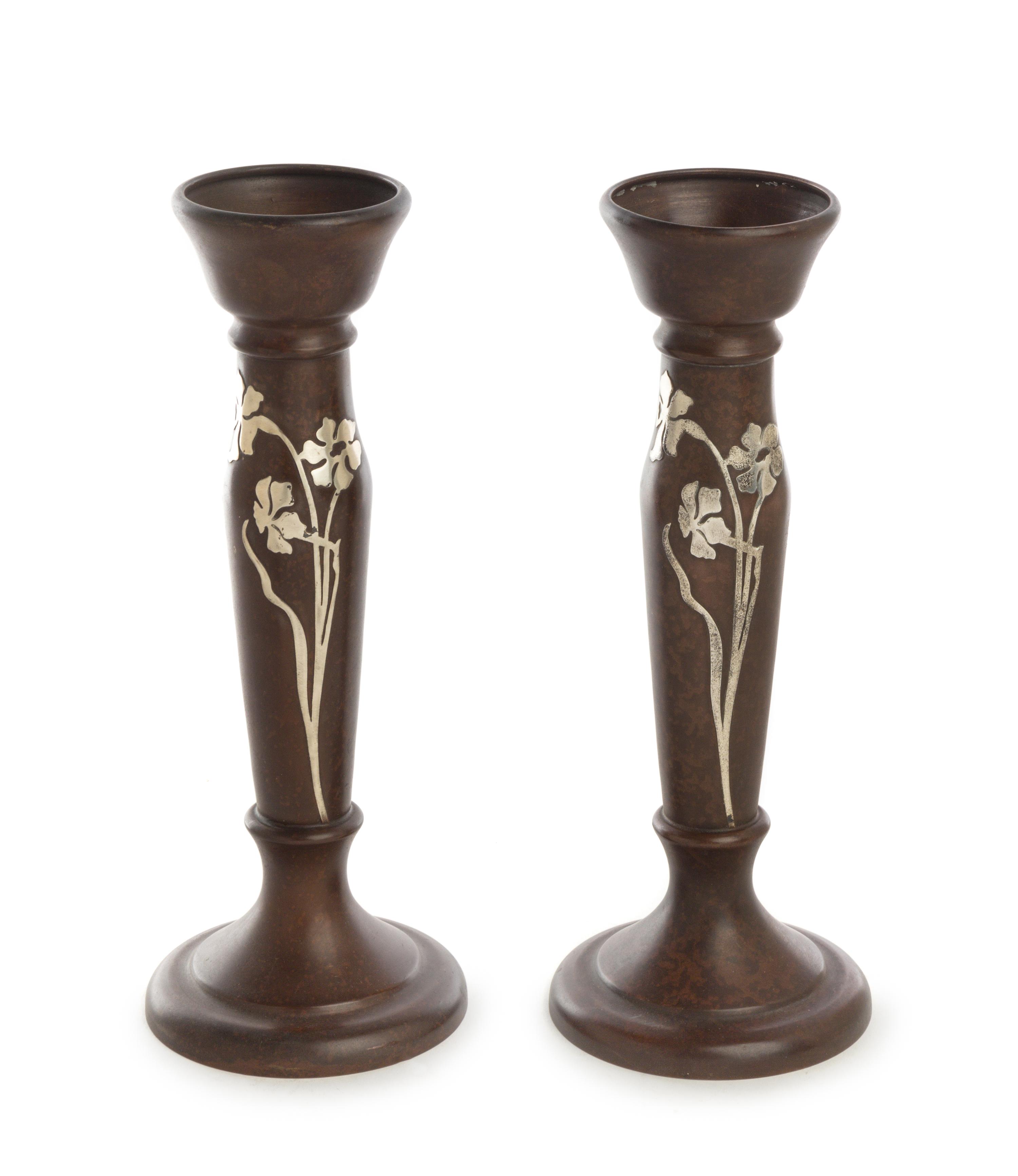 A Pair of American Art Nouveau Silver Inlaid Bronze Candlesticks, Heintz Art Metal Shop, Buffalo, NY, the bronze stem of baluster form,