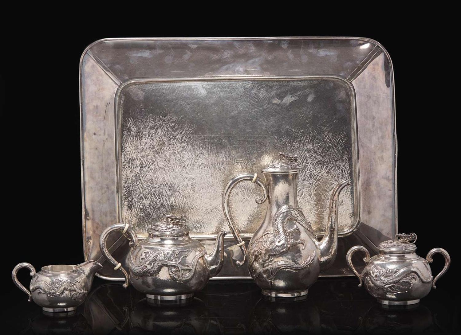 An impressive Japanese export silver four-piece "Dragon" tea and coffee service with tray, retailed by Arthur & Bond, Yokohama, late 19th/early 20th century 日式銀質咖啡器茶具四件及托盤 十九世紀末或二十世紀初