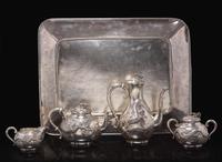 An impressive Japanese export silver four-piece "Dragon" tea and coffee service with tray, retailed by Arthur & Bond, Yokohama, late 19th/early 20th century 日式銀質咖啡器茶具四件及托盤 十九世紀末或二十世紀初