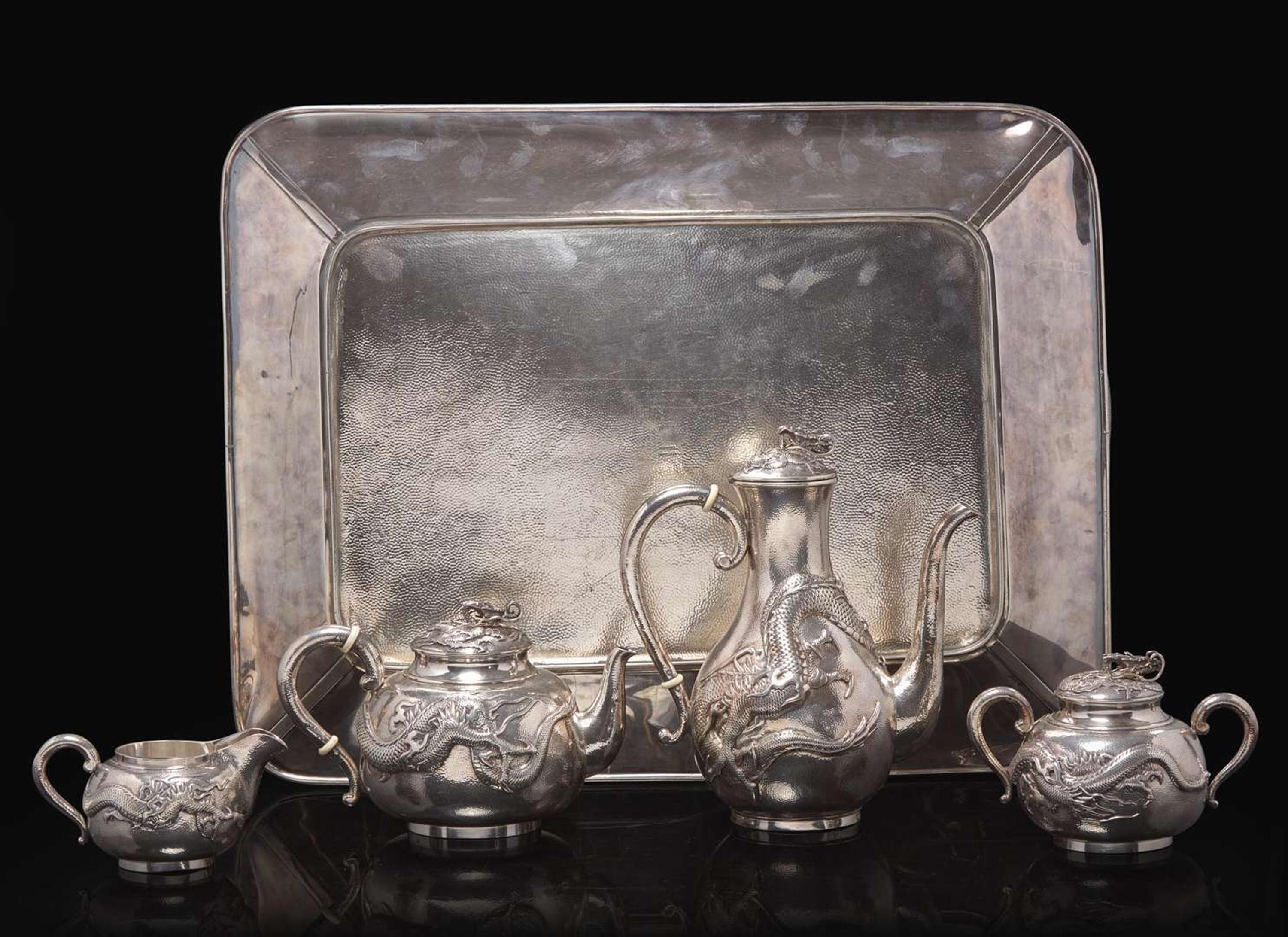 An impressive Japanese export silver four-piece "Dragon" tea and coffee service with tray, retailed by Arthur & Bond, Yokohama, late 19th/early 20th century 日式銀質咖啡器茶具四件及托盤 十九世紀末或二十世紀初