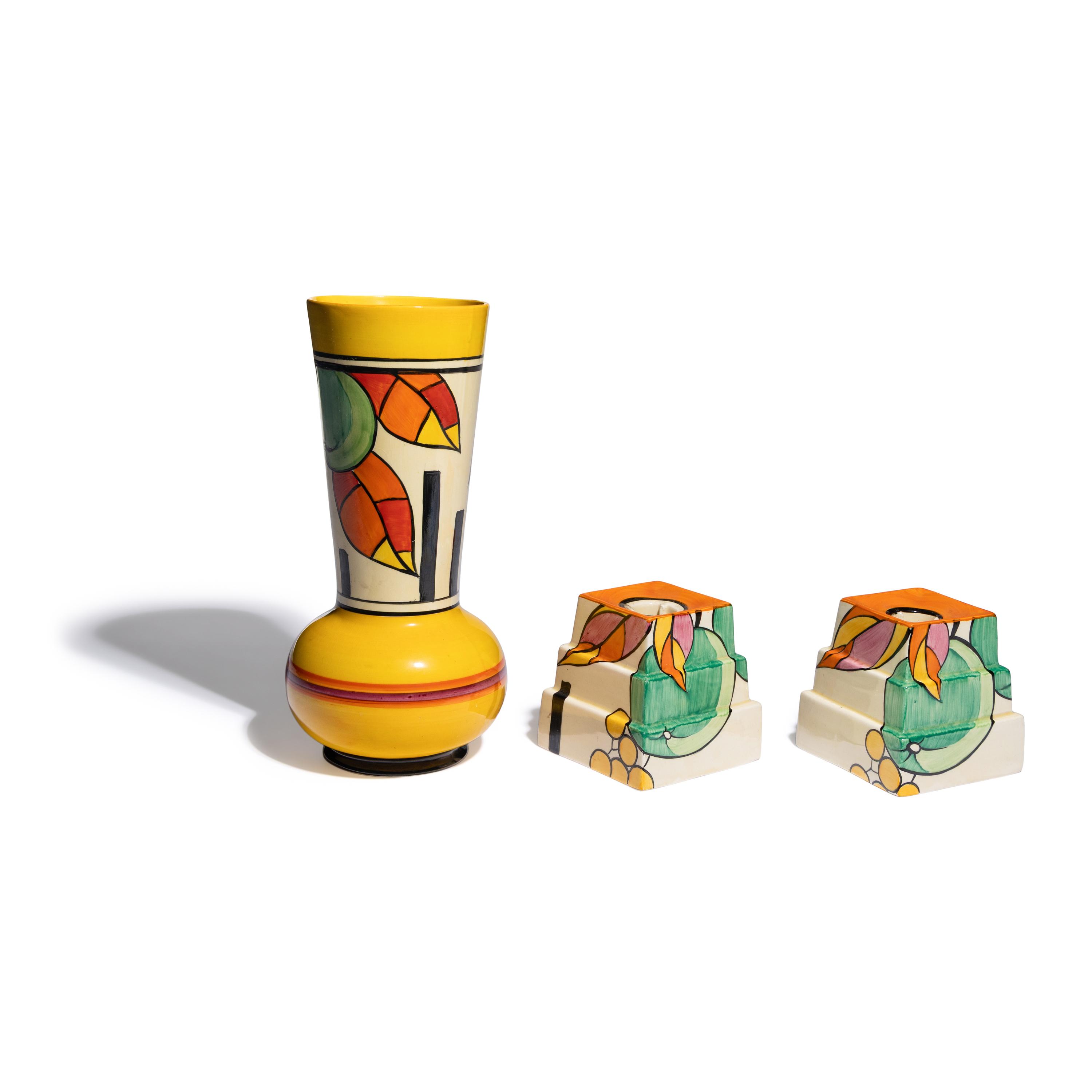 Clarice Cliff (English, 1899-1972) — Apples pattern Vase and two Candlesticks, c. 1931-32