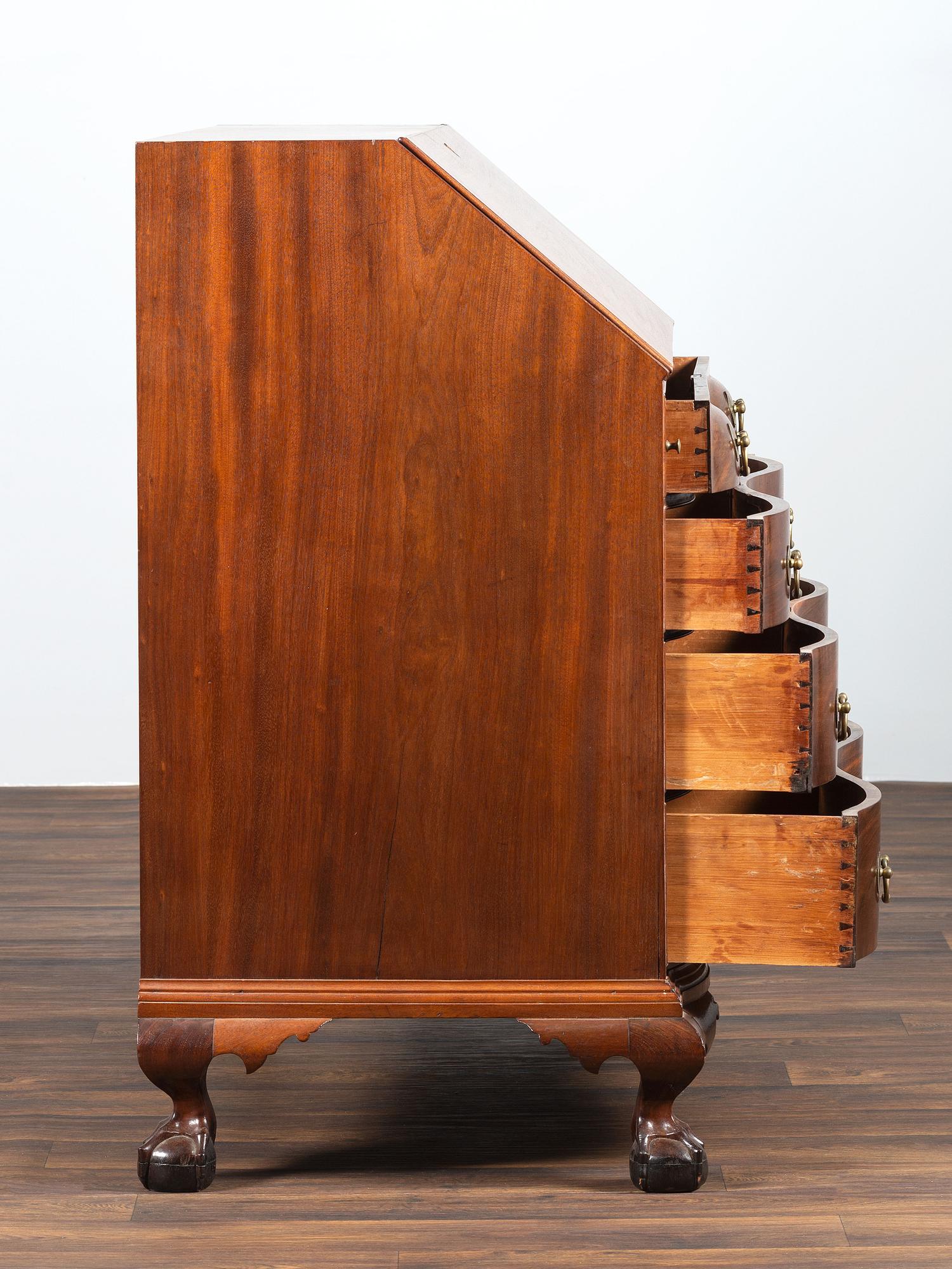 A Chippendale Carved Mahogany Reverse Serpentine Block-Front Desk