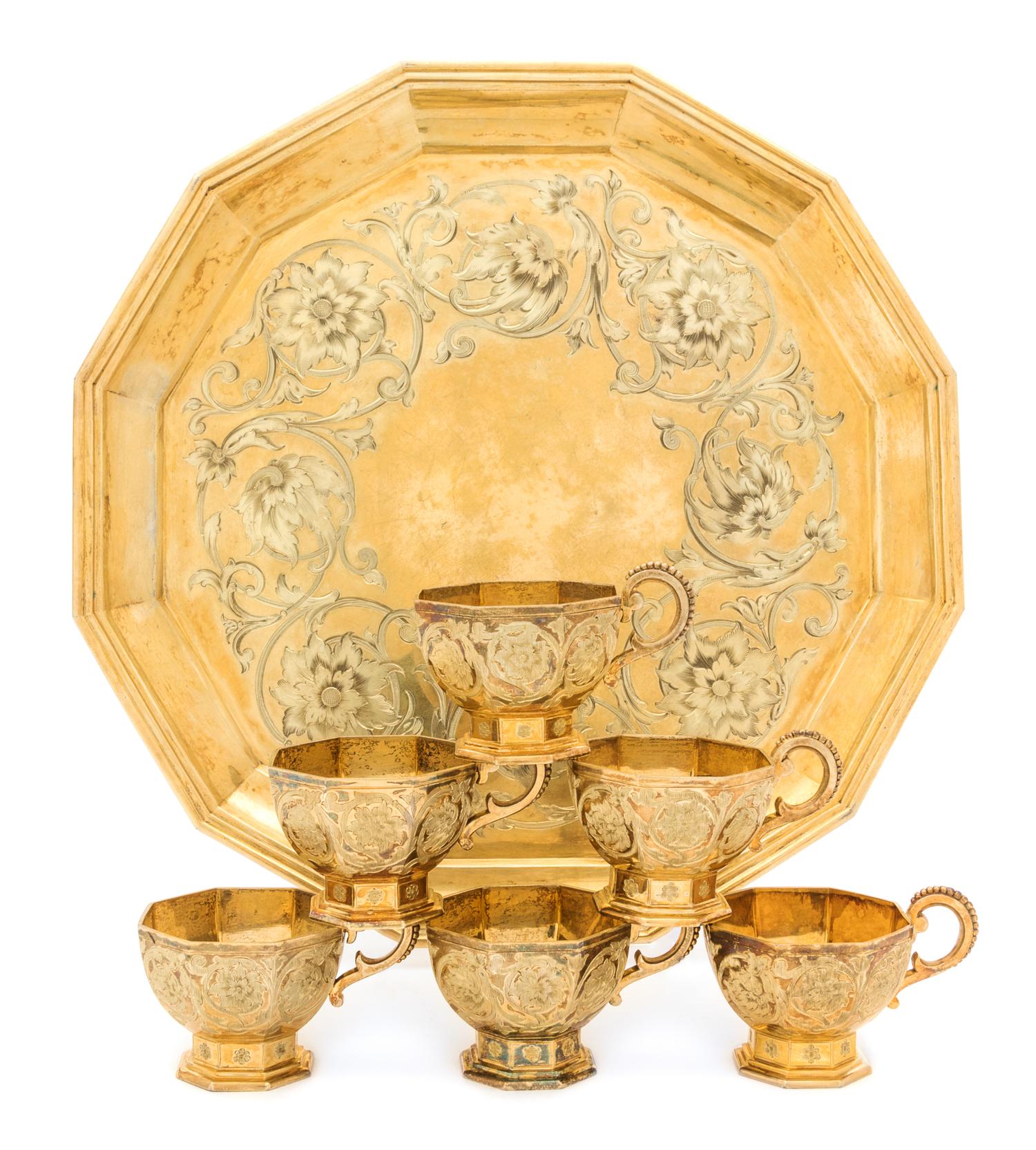 A Russian Silver-Gilt Liquor Service, Mark of Sazikov with Imperial Warrant, Moscow, 1861, comprising six cups and a tray, the cups of