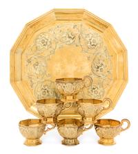 A Russian Silver-Gilt Liquor Service, Mark of Sazikov with Imperial Warrant, Moscow, 1861, comprising six cups and a tray, the cups of