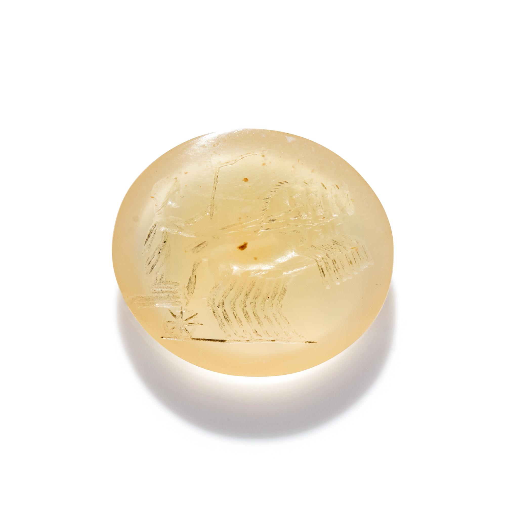 A Roman Chalcedony Ring Stone with a Charioteer Driving a Quadriga