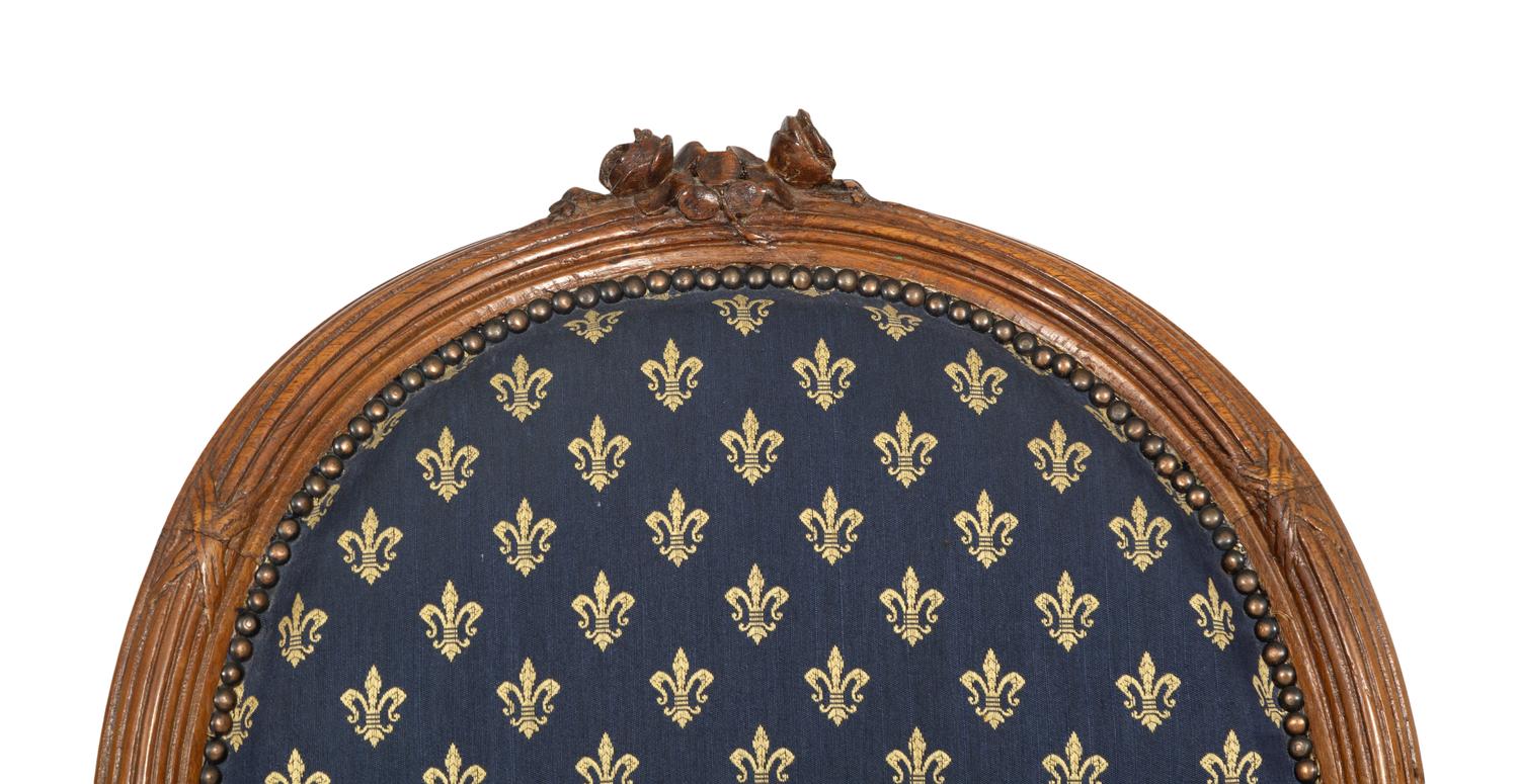 A Pair of Louis XVI Style Walnut Fauteuils
