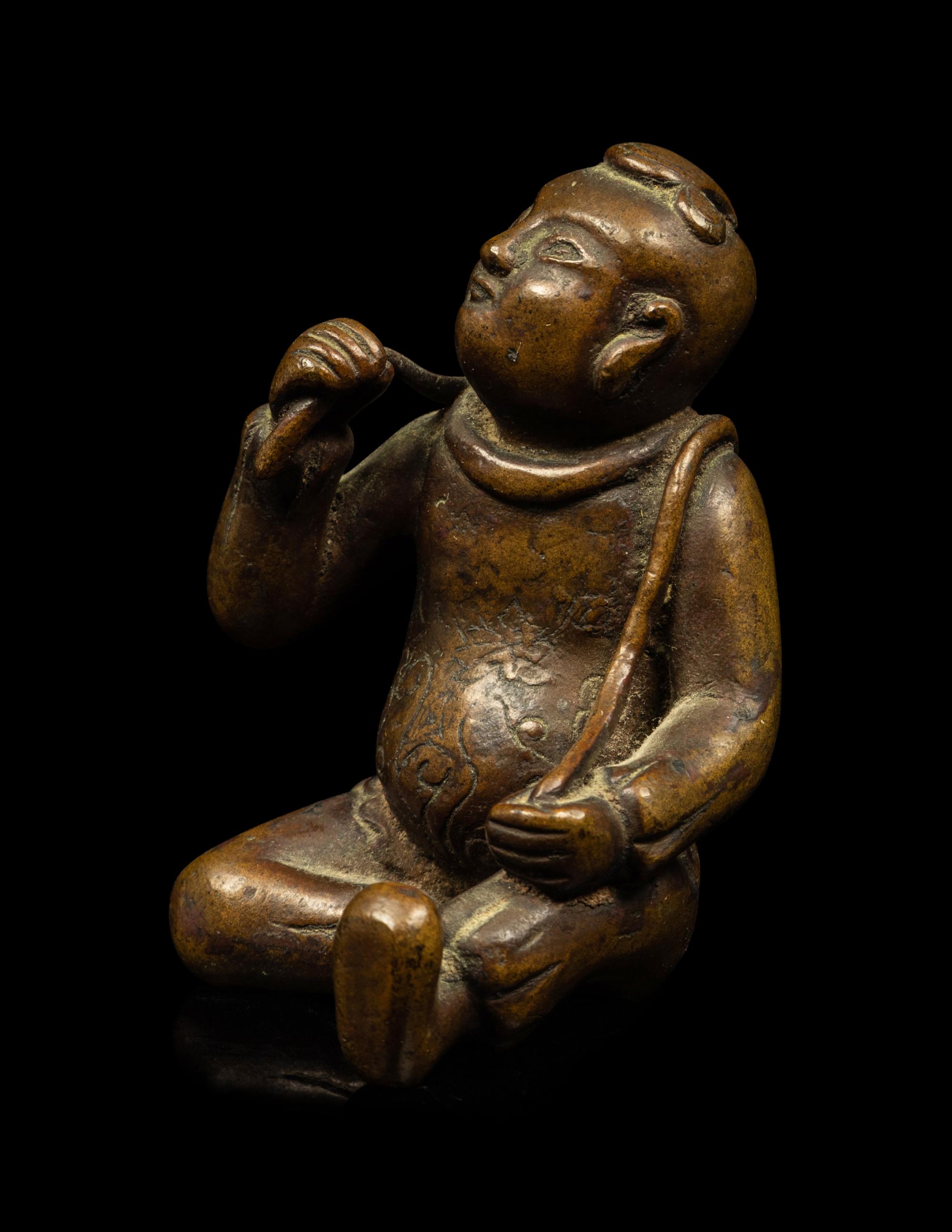 A Small Chinese Bronze Figure of a Seated Boy