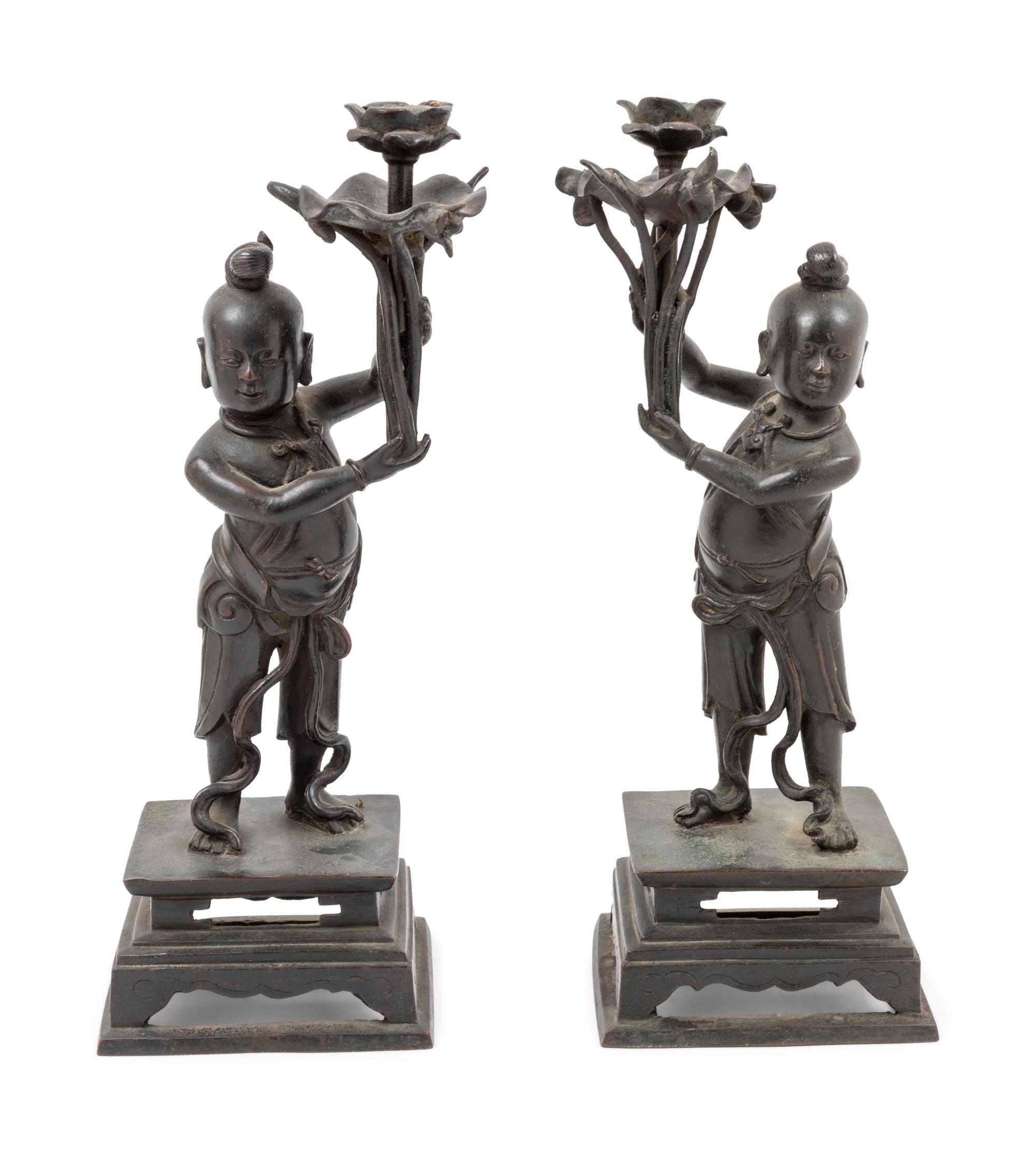 A Pair of Bronze 'Boy' Candle Holders