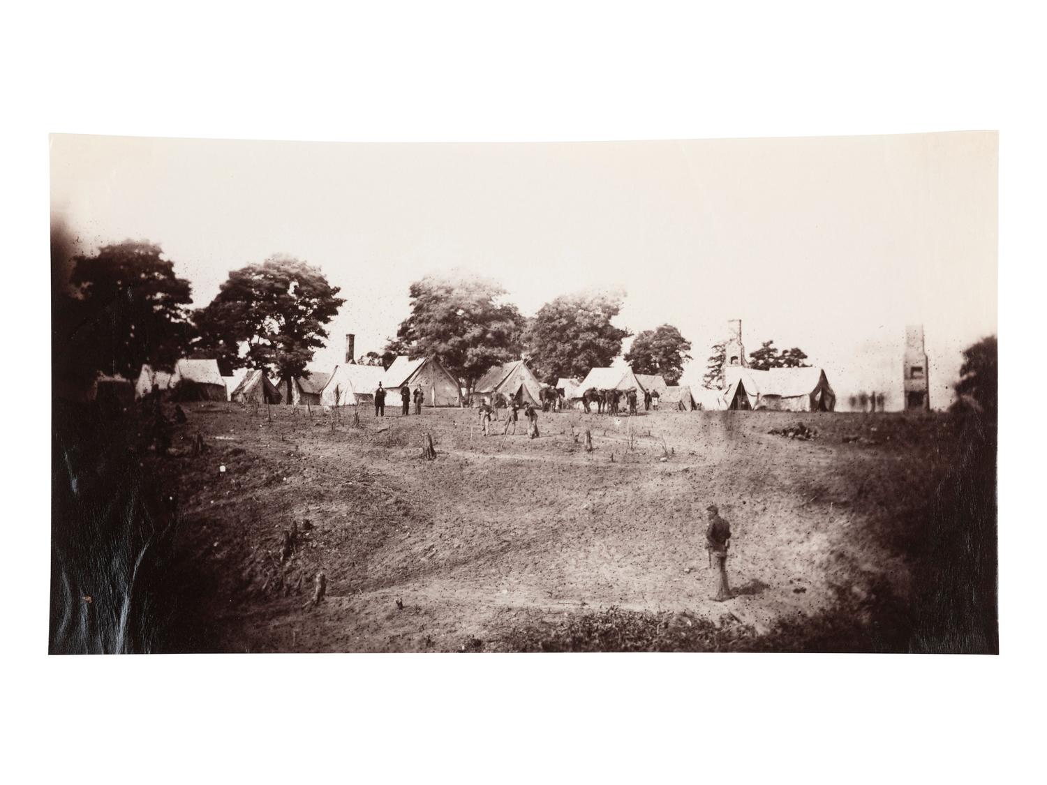 [CIVIL WAR]. Photographer unknown. Unidentified Union Encampment with ruined chimneys in the background. 1861-1865.