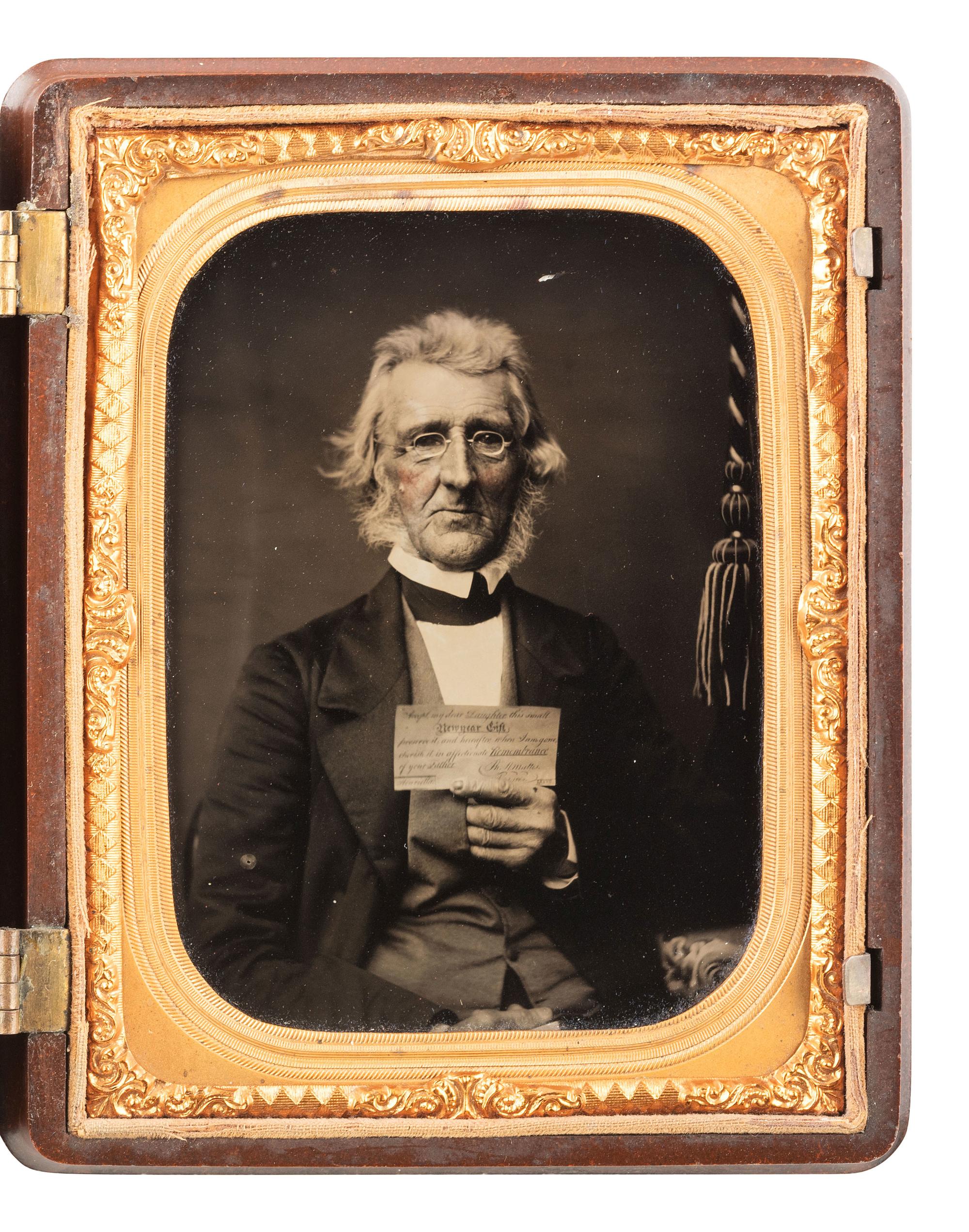 [EARLY PHOTOGRAPHY]. Quarter plate ambrotype of an aged gentleman holding up an affectionate note to his daughter. Ca 1862.