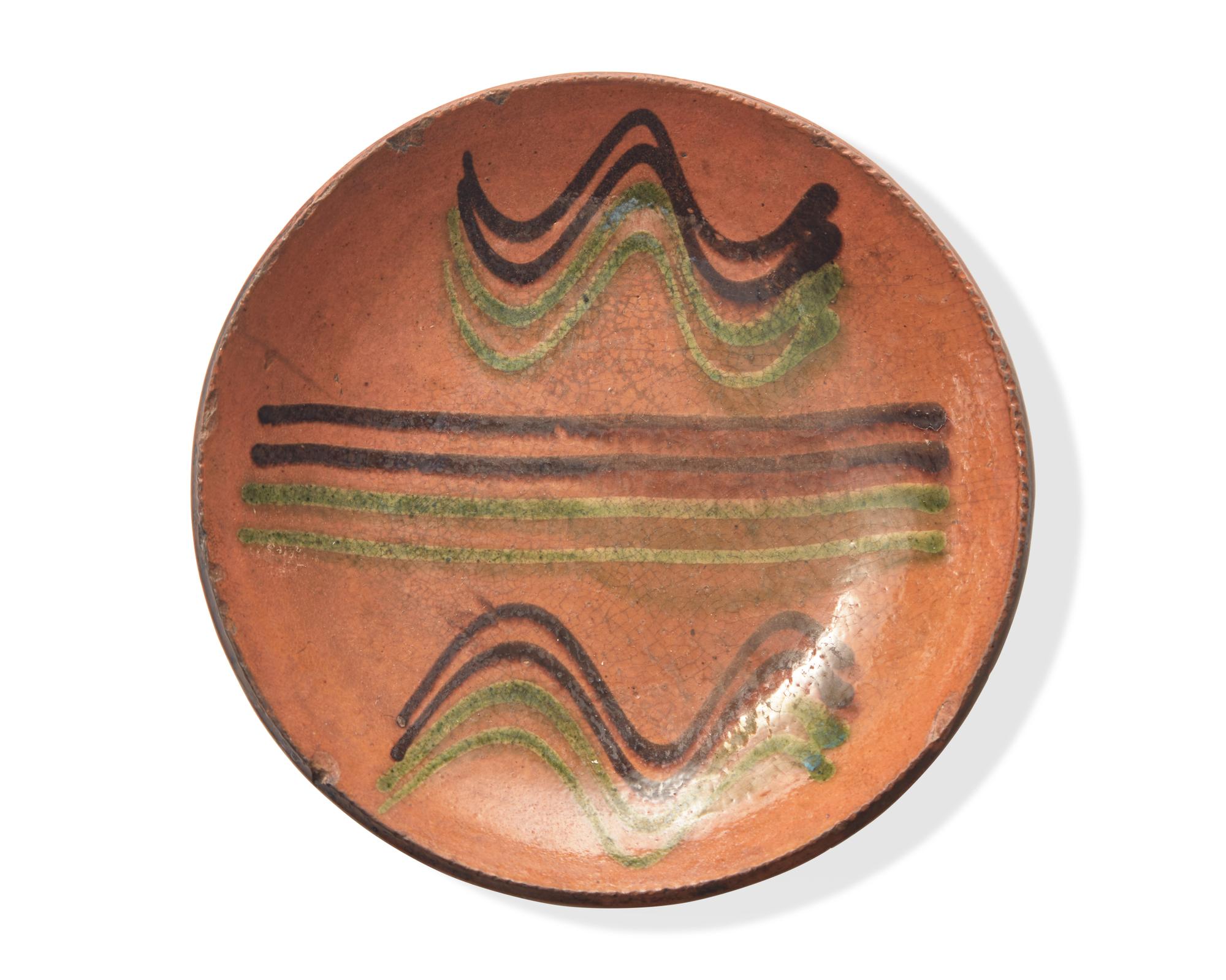 A Green and Brown Slip-Decorated Redware Pie Plate, Dryville, Pennsylvania, 19th Century