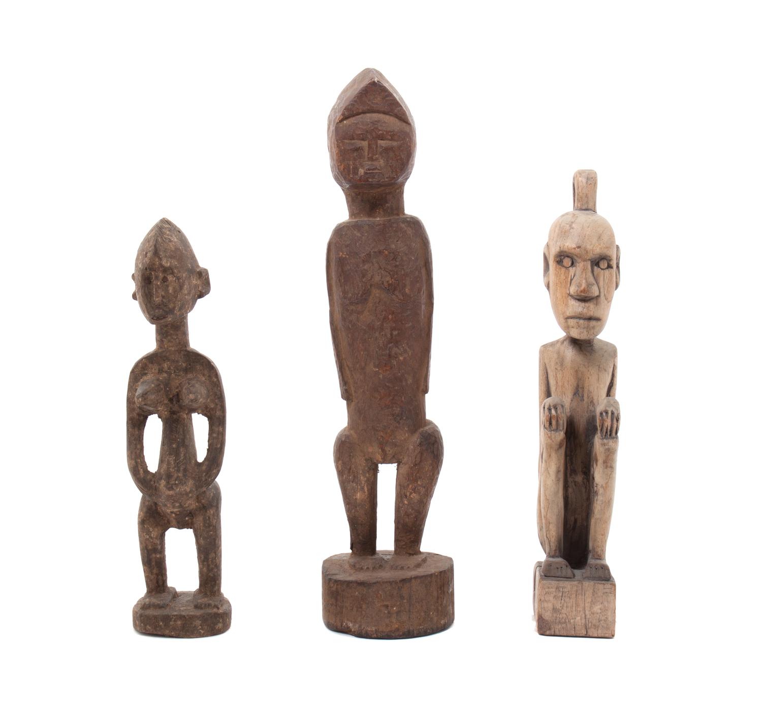 Three Carved Wood African Figures Height of tallest 14 inches.