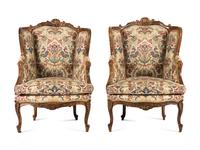 A Pair of Louis XV Style Carved Walnut Bergères