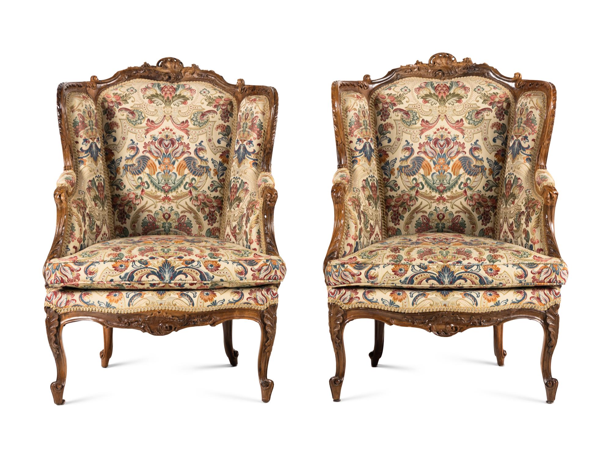 A Pair of Louis XV Style Carved Walnut Bergères