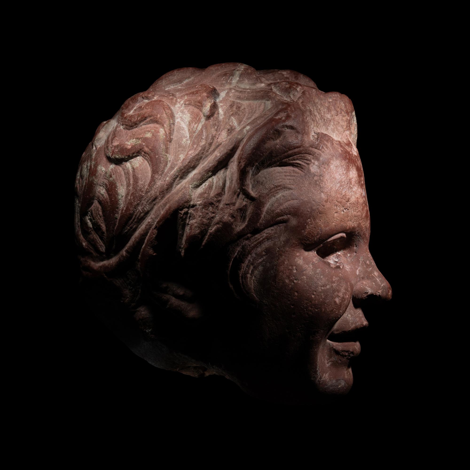 A Roman Rosso Antico Head of a Young Satyr