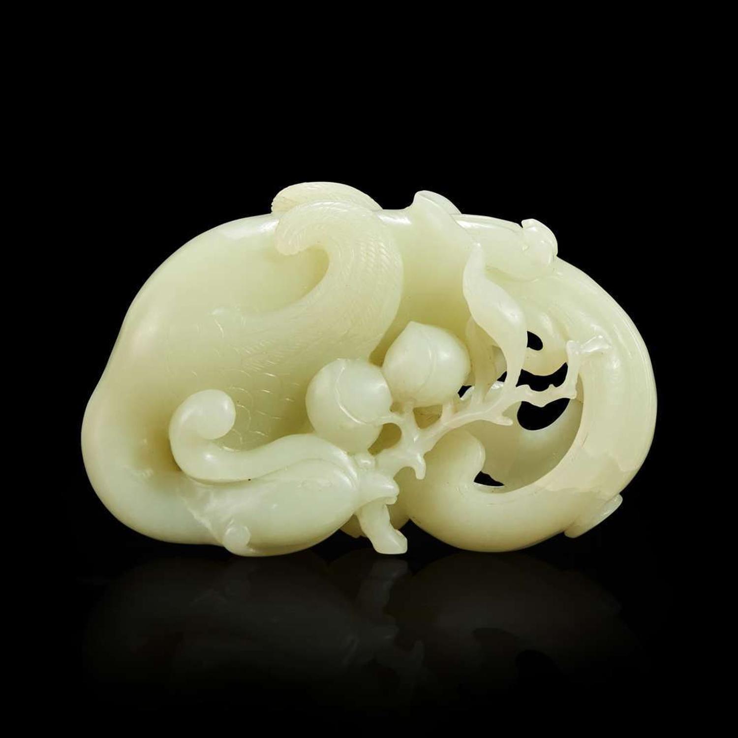 A Chinese carved white jade "Phoenix and Peach" large ornament