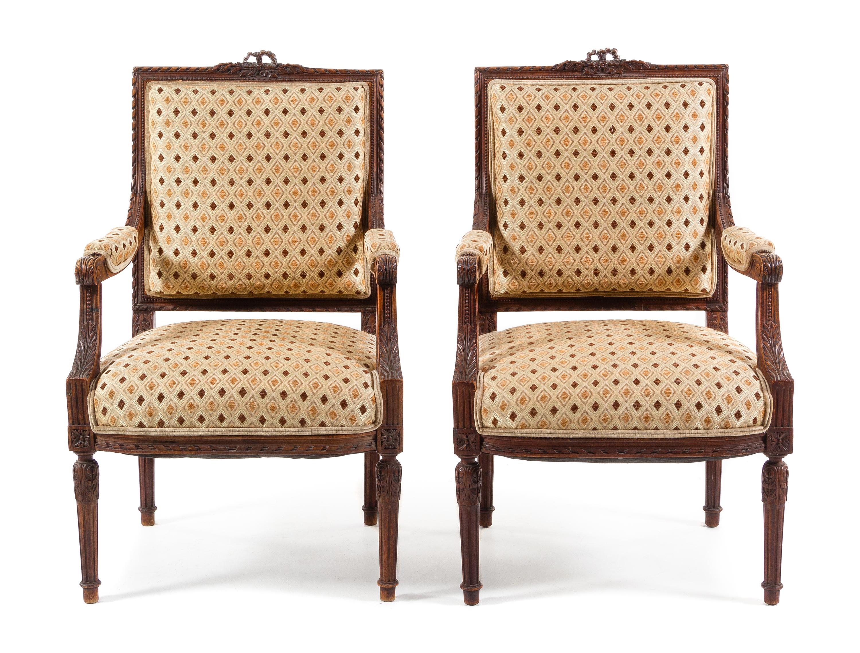 A Pair of Louis XVI Style Walnut Fauteuils Height 39 1/8 inches. — 19TH CENTURY