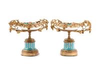 A Pair of Sèvres Style Gilt Bronze Mounted Painted and Parcel Gilt Porcelain Tazze