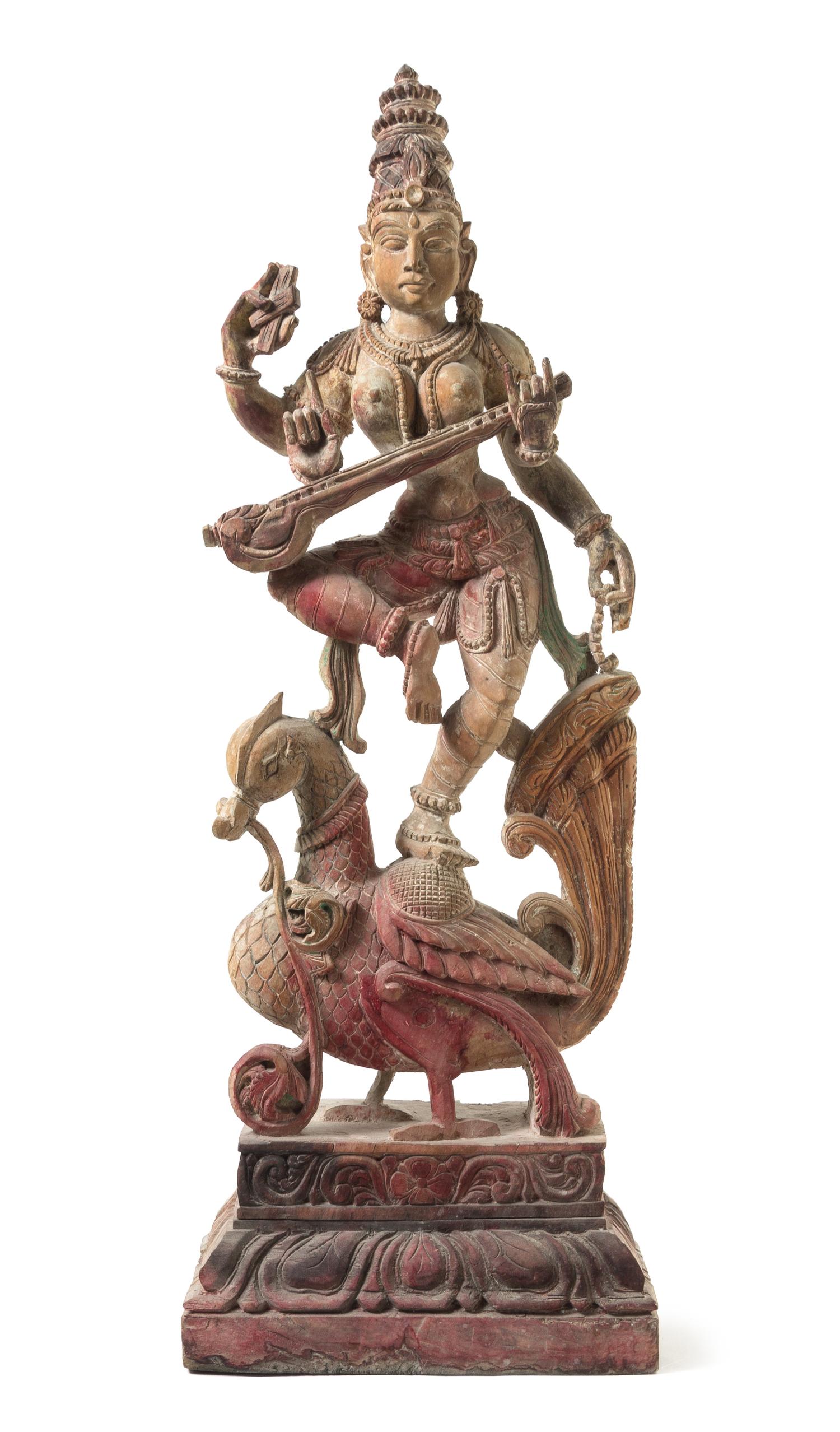 An Indian Polychrome Wood Figure of a Dancing Deity Height 35 1/4 inches.