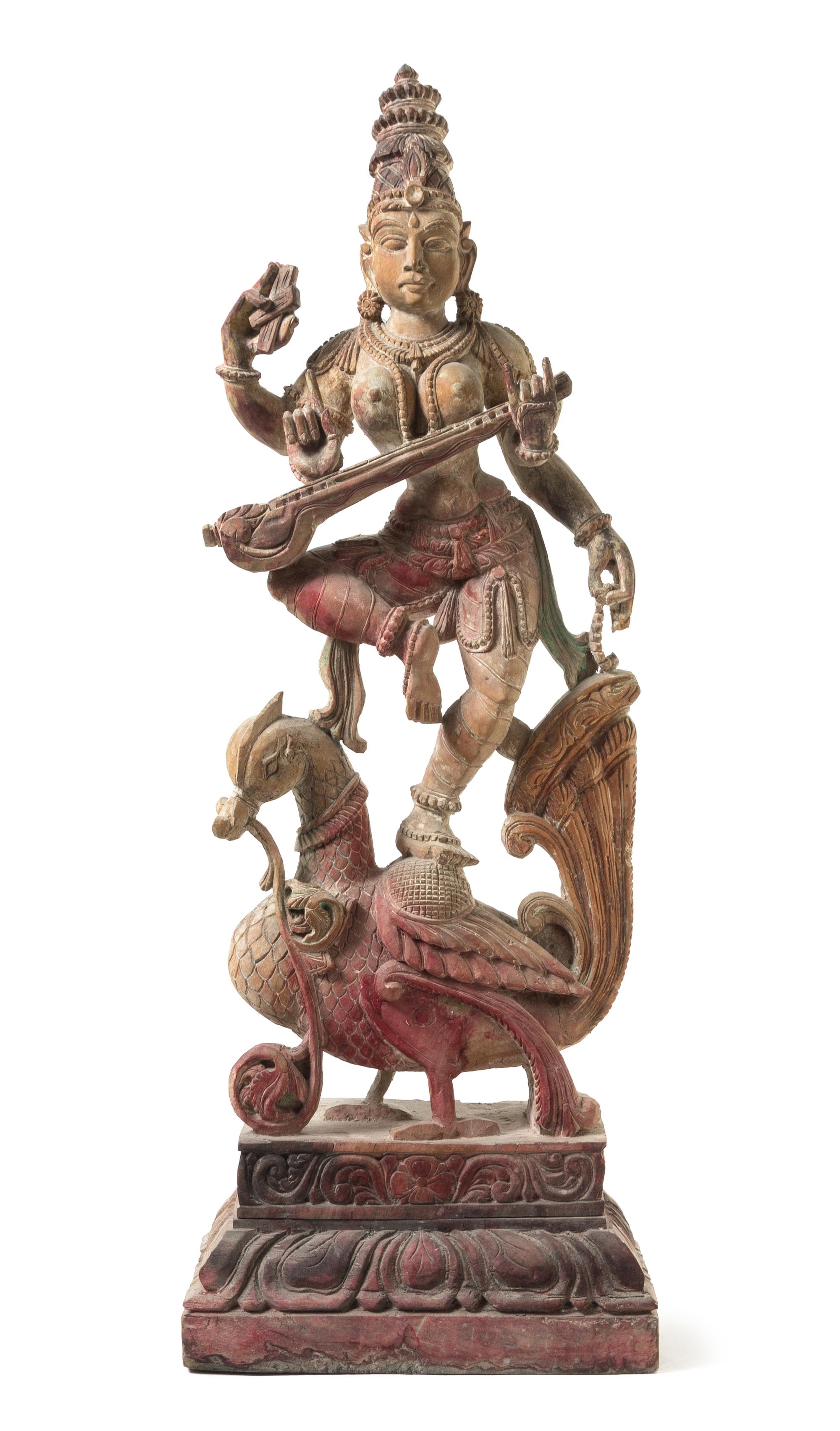An Indian Polychrome Wood Figure of a Dancing Deity Height 35 1/4 inches.