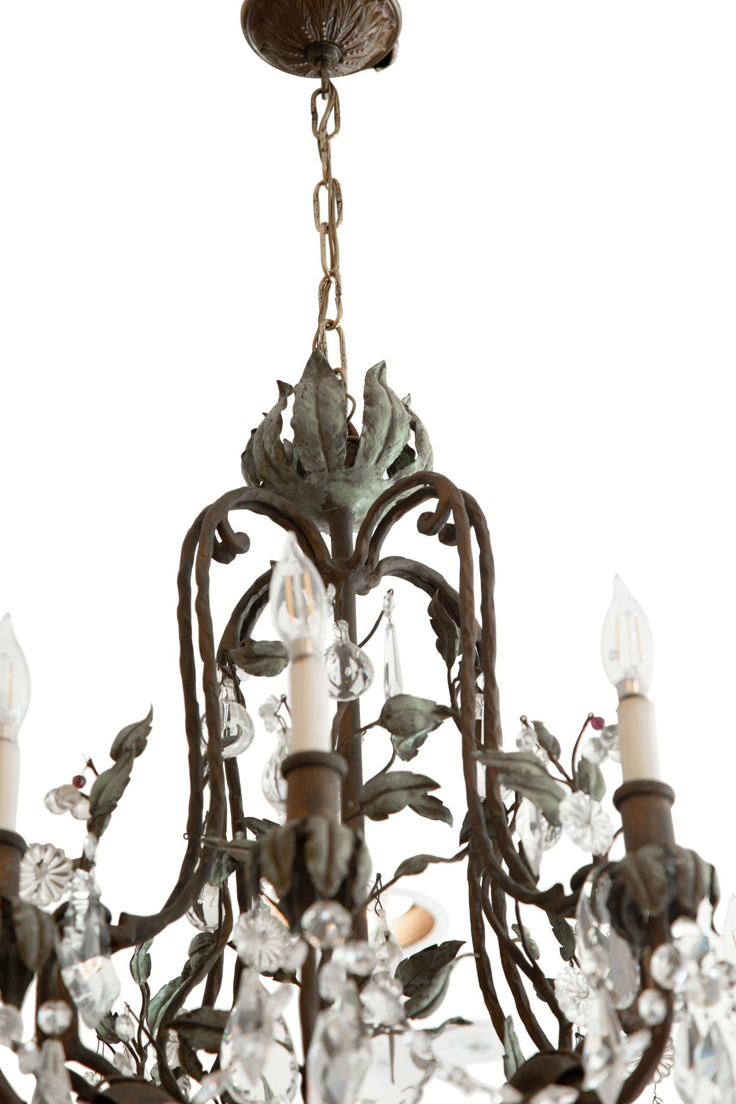 A Continental Patinated Bronze, Tole and Cut Glass Twelve-Light Chandelier