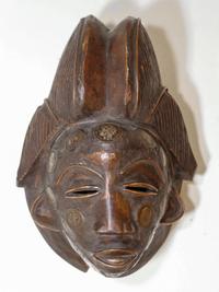 An African Carved Wood Mask, Ivory Coast Length 10 1/2 inches.