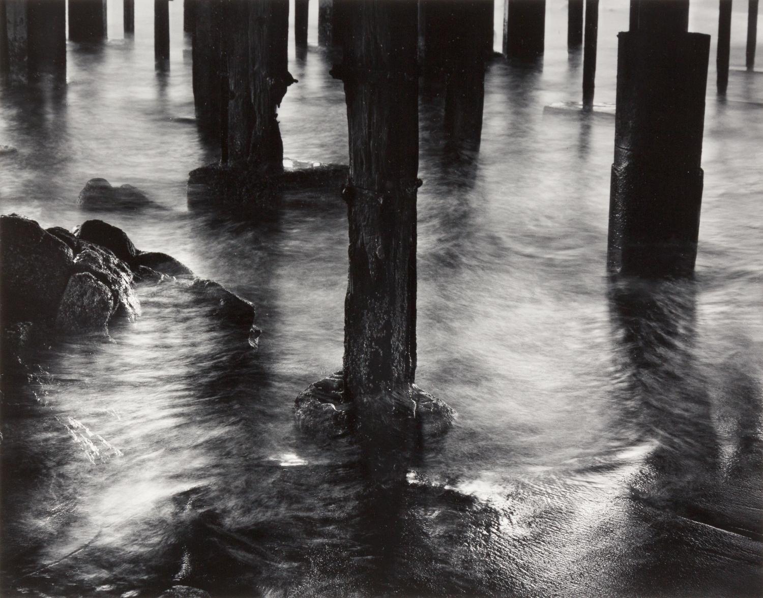 Wynn Bullock, (American, 1902-1975), Pilings under Cannery Row, 1958