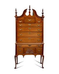 A Queen Anne Carved Walnut Bonnet-Top High Chest of Drawers