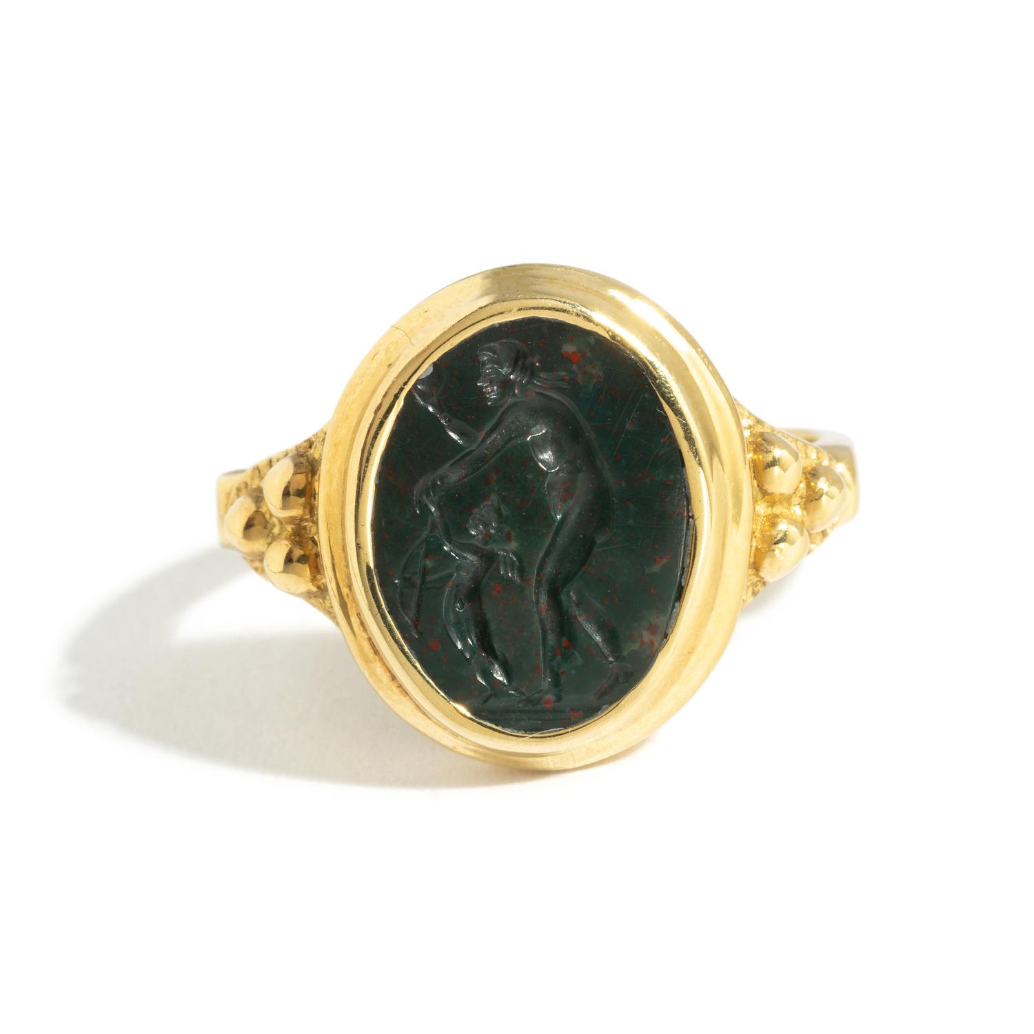 A Roman Bloodstone Double-Sided Ring Stone with the Gods Venus and Eros & a Portrait Head of a Deity — Set in a gold ring, '18k' stamped on inside