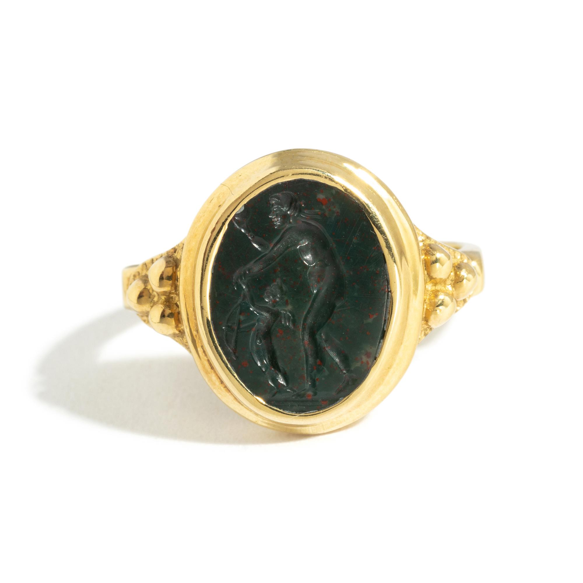 A Roman Bloodstone Double-Sided Ring Stone with the Gods Venus and Eros & a Portrait Head of a Deity — Set in a gold ring, '18k' stamped on inside