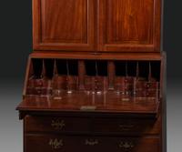 A Chippendale Figured Mahogany Bonnet Top Desk-and-Bookcase