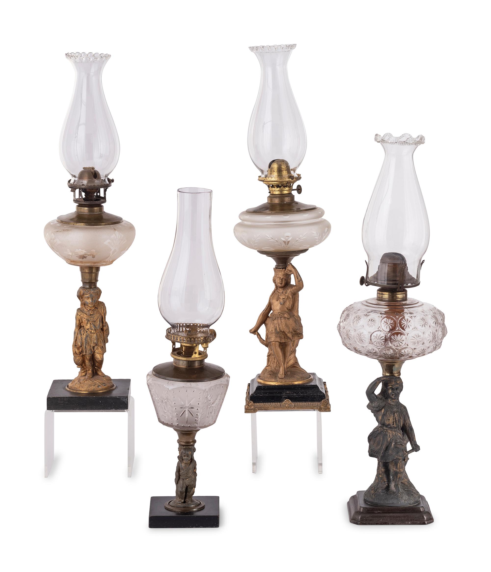Four Gilt Metal and Glass Figural Oil Lamps