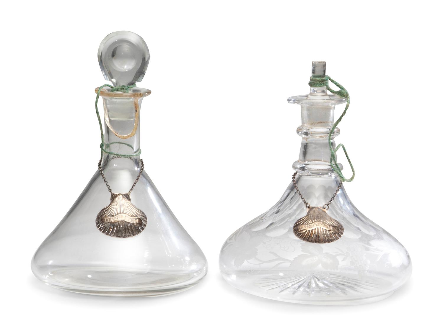 Fifteen Glass Decanters with English Shell-Form Silver Bottle Tags