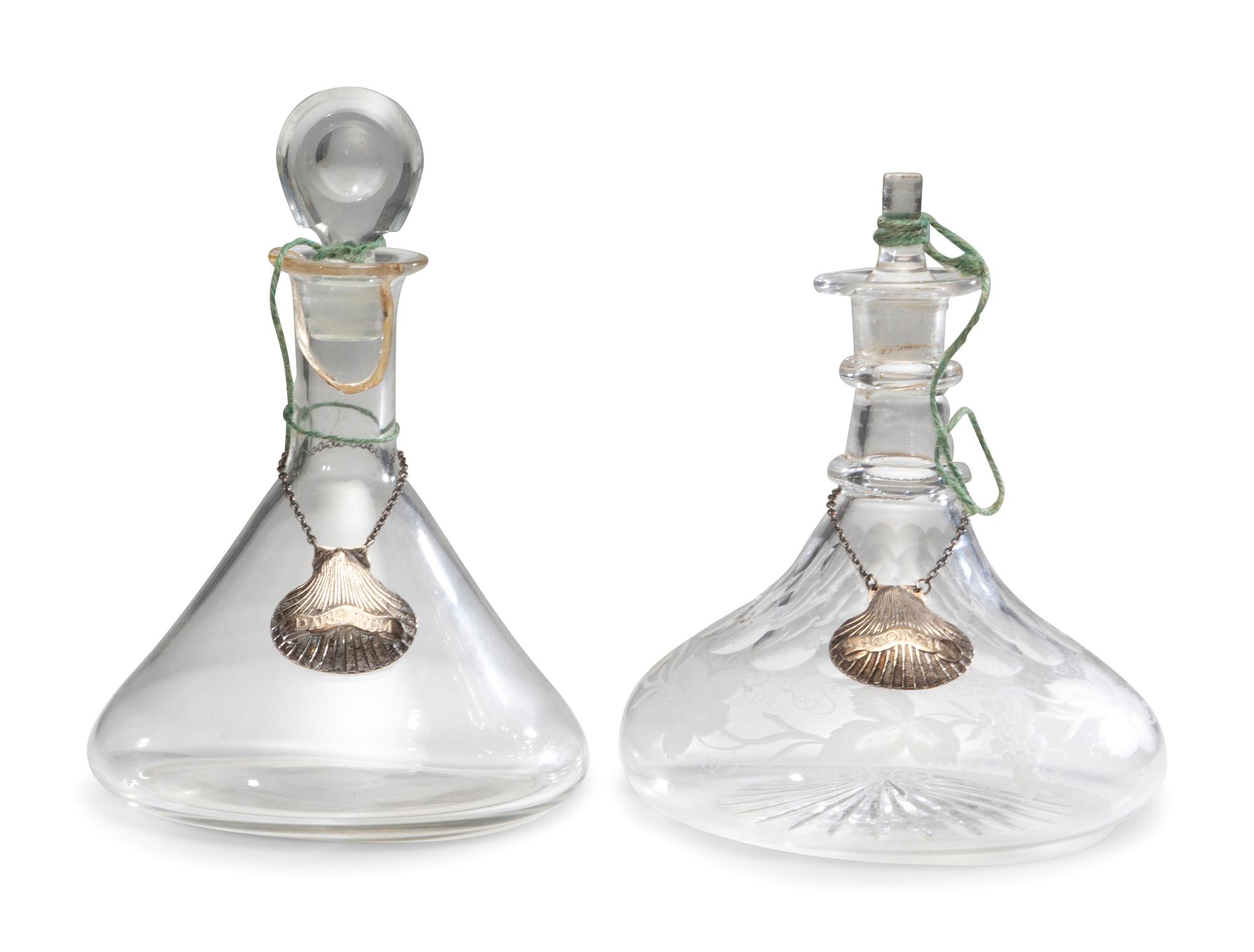 Fifteen Glass Decanters with English Shell-Form Silver Bottle Tags