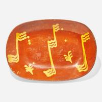 A glazed and slip-decorated redware loaf dish Pennsylvania, 19th century