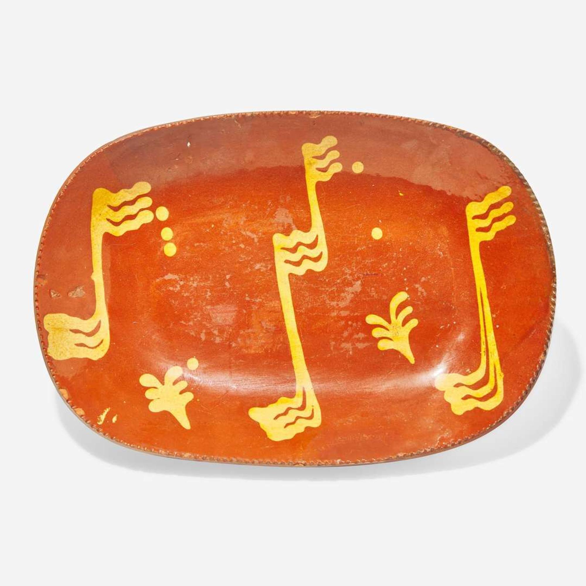 A glazed and slip-decorated redware loaf dish Pennsylvania, 19th century
