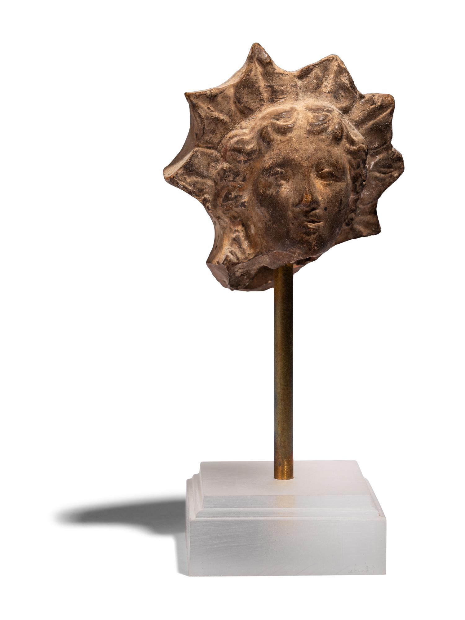 A Greek Terracotta Head of Helios