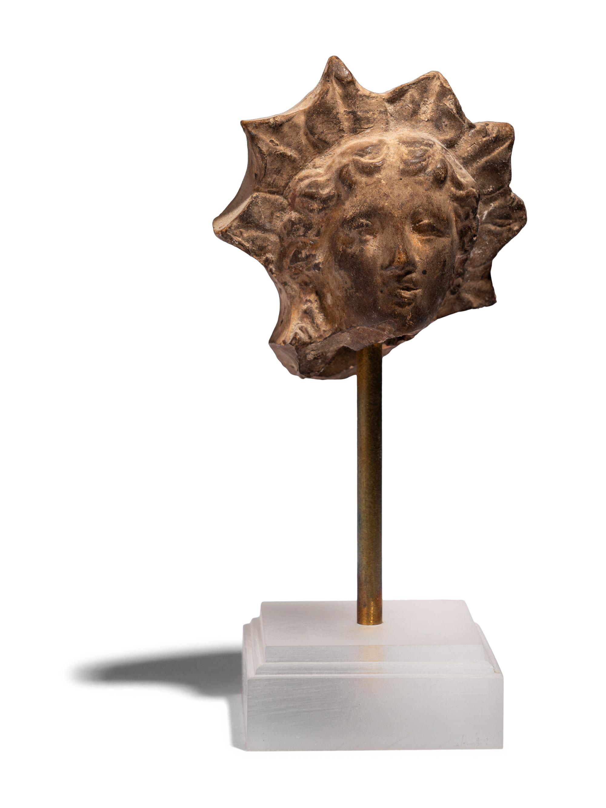 A Greek Terracotta Head of Helios
